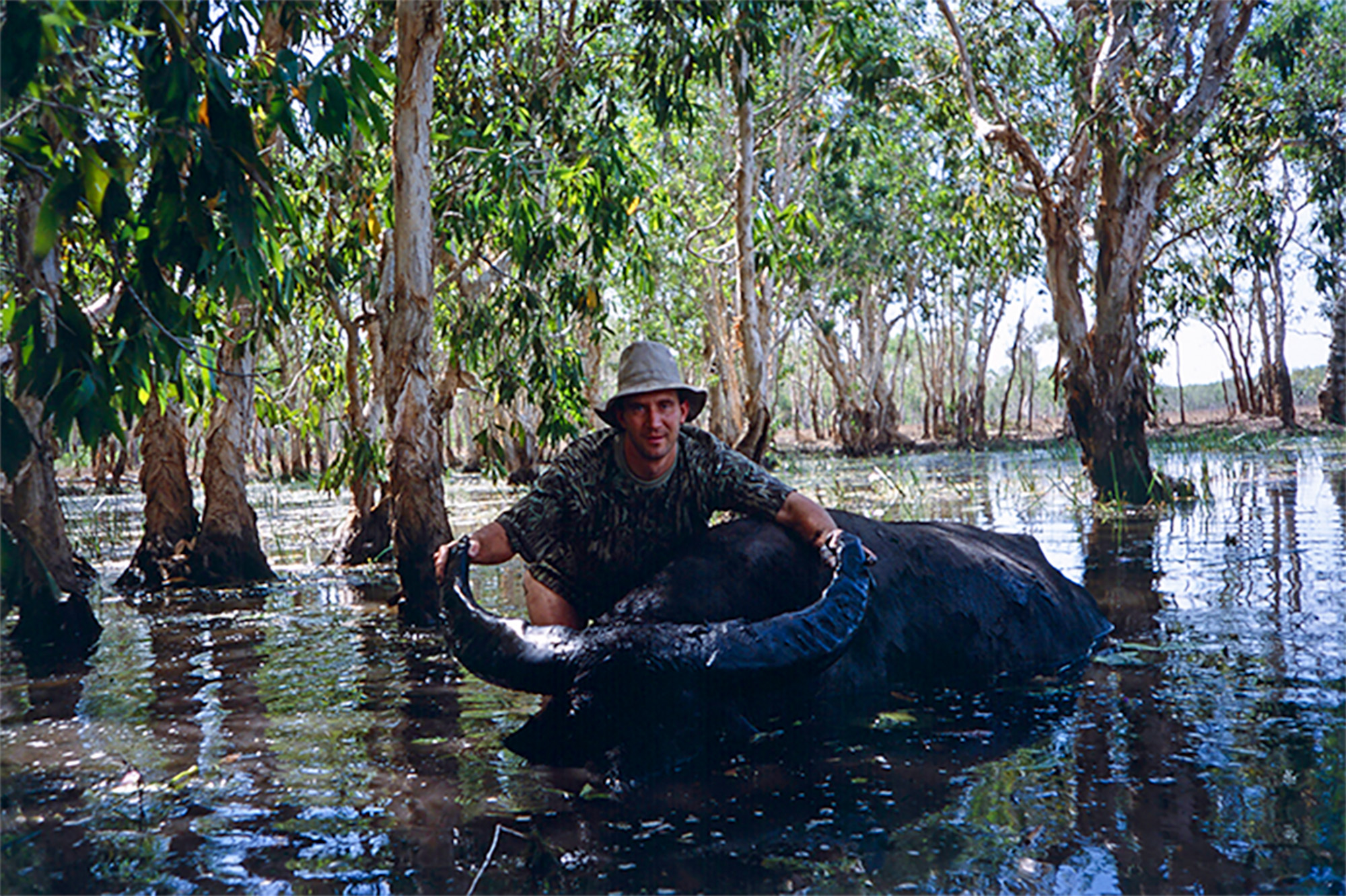 Scott Haugen with a buffalo in the water.