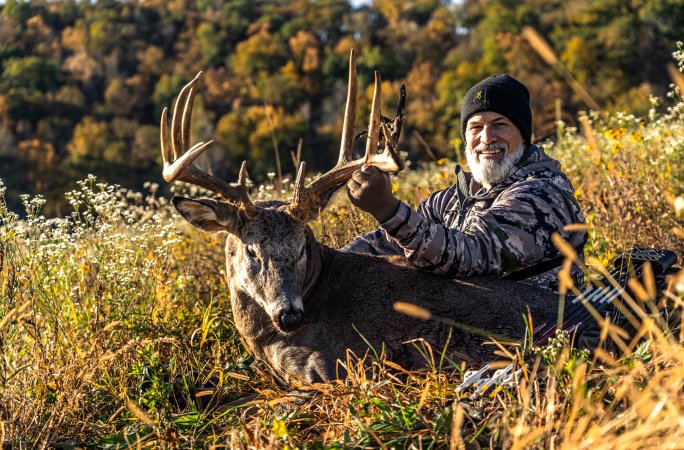 A Minnesota bowhunter with a 12-point buck.