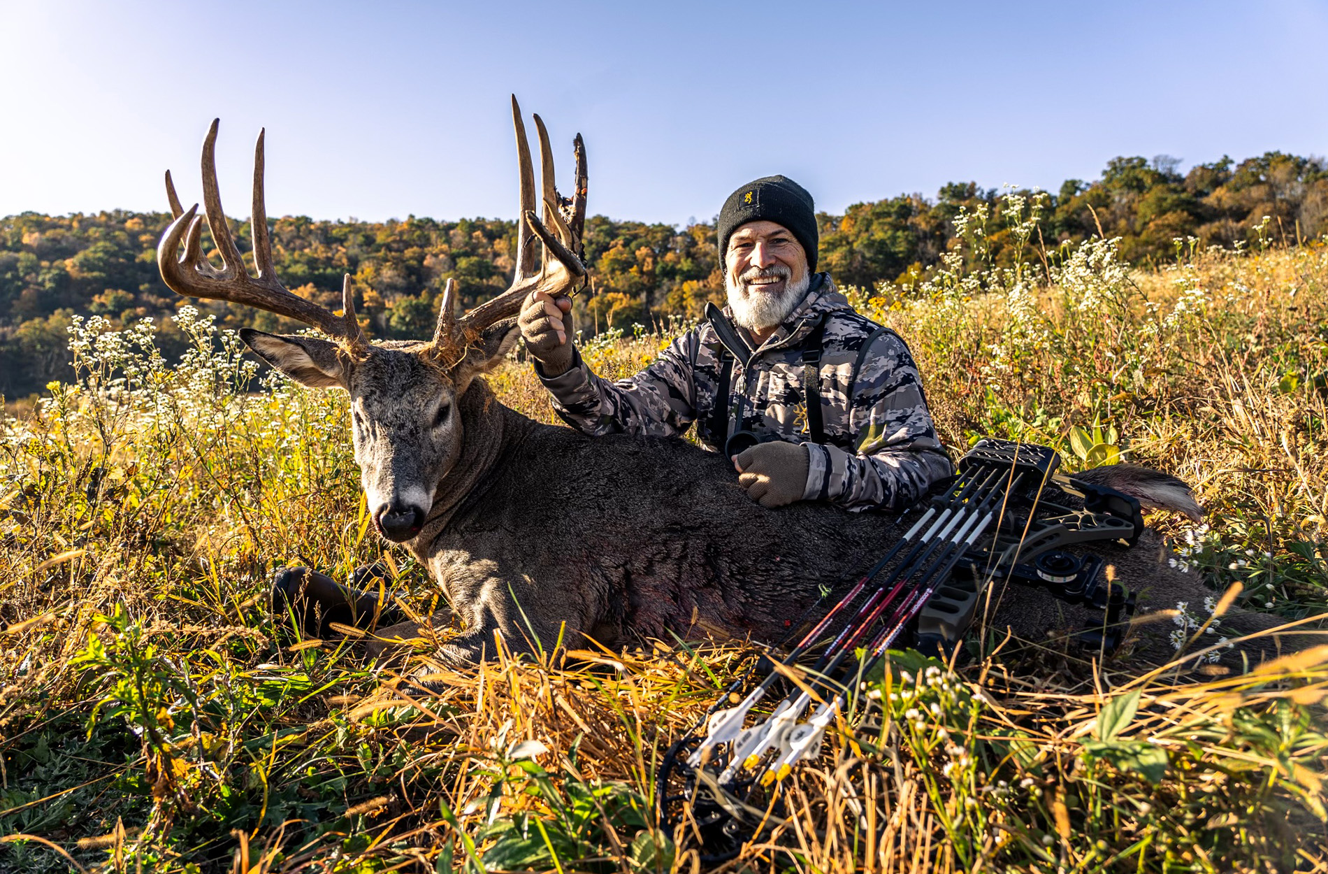 Minnesota bowhunter with whitetail buck.