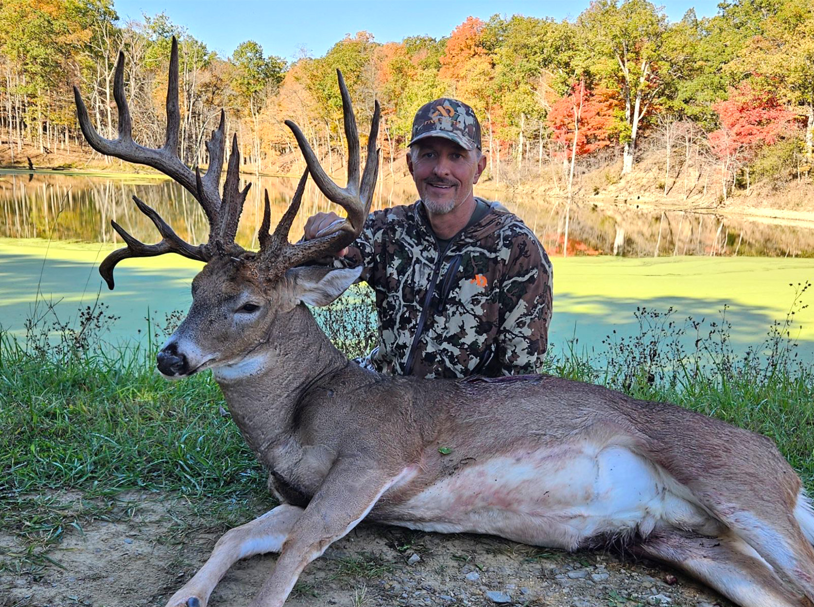 A crossbow hunter with a giant Ohio buck.