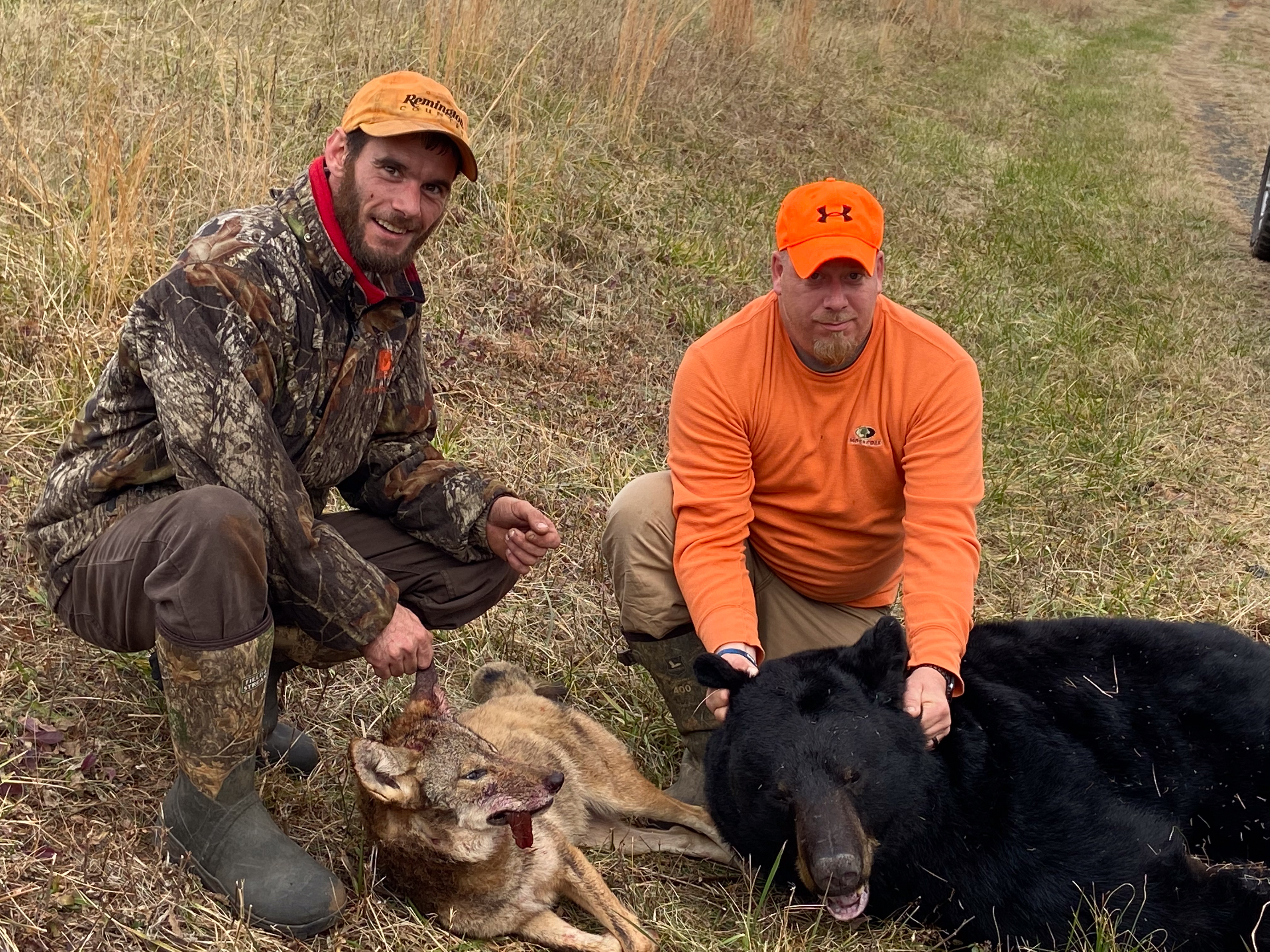 A hunter with a coyote and a bear