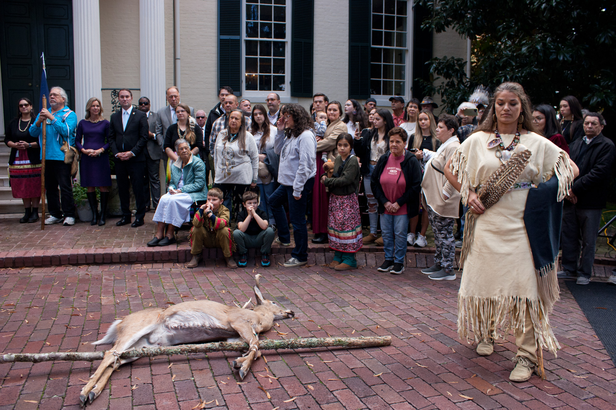 A deer lies on the ground outside the Virginia governor's mansion.