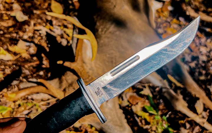 A big Buck 119 Knife with a deer in the background.