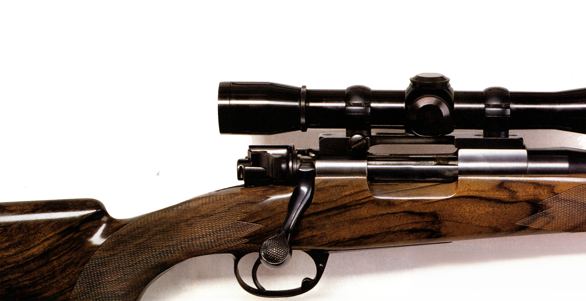 A photograph of a glossy wood-stocked deer rifle.