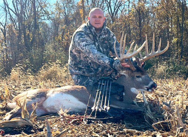 A bowhunter with a big buck in Illinois.