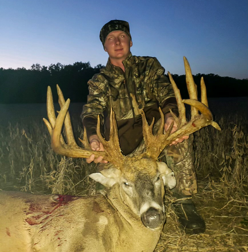 A deer hunter with a 30-point buck.