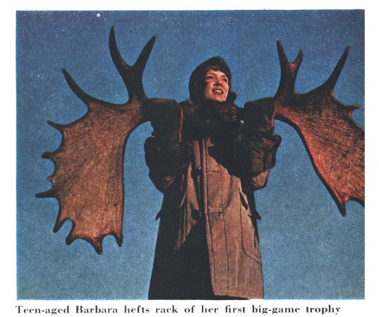 A 16-year-old holds up moose antlers against a blue sky in a vintage photo