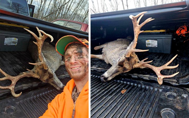 A hunter with a buck loaded into a truck bed.