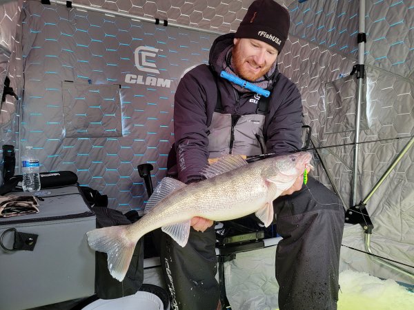 ice fisherman Ross Robertson holds up a nice fish