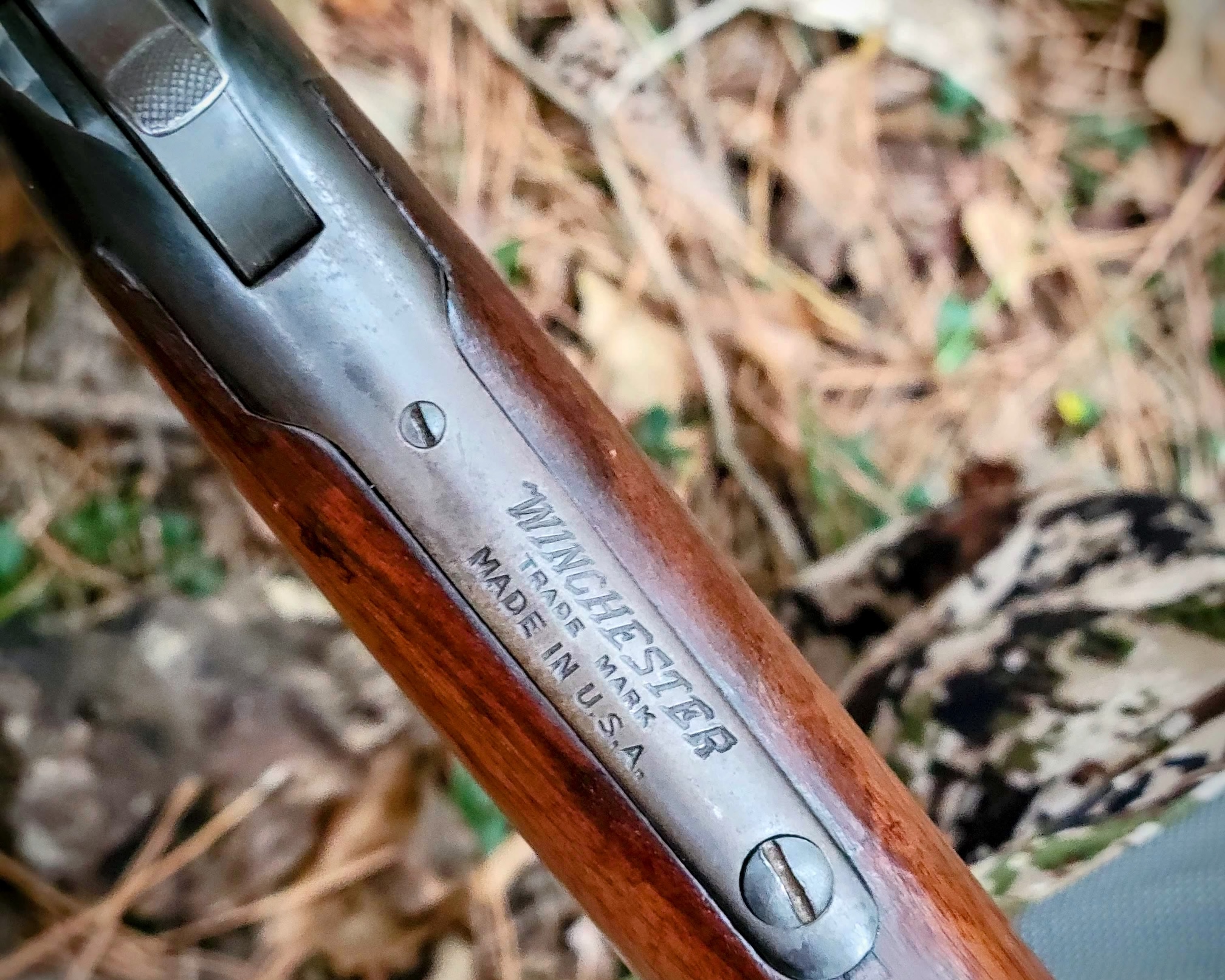 A close up of the manufacturer's mark on a vintage Winchester Model 94.