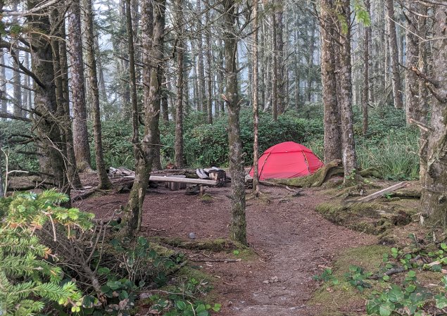 Red Hilleberg Allak 3 set against a misty forest background