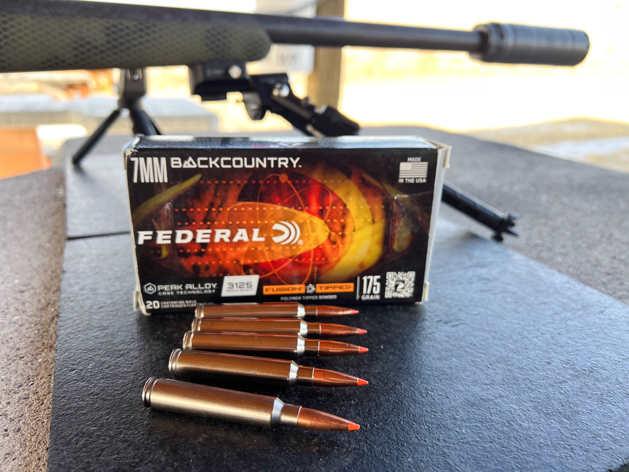 A box of 175-grain Fusion Tipped cartridges in 7 BC on a shooting bench