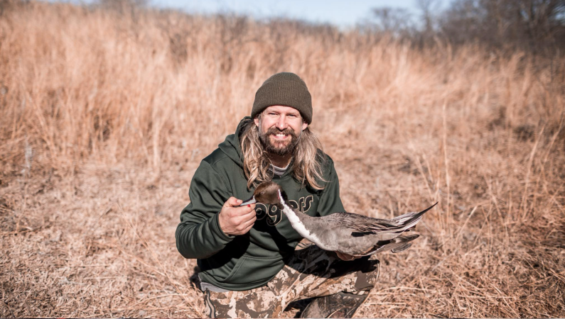 Mikey Stovall holds a pintail. He was