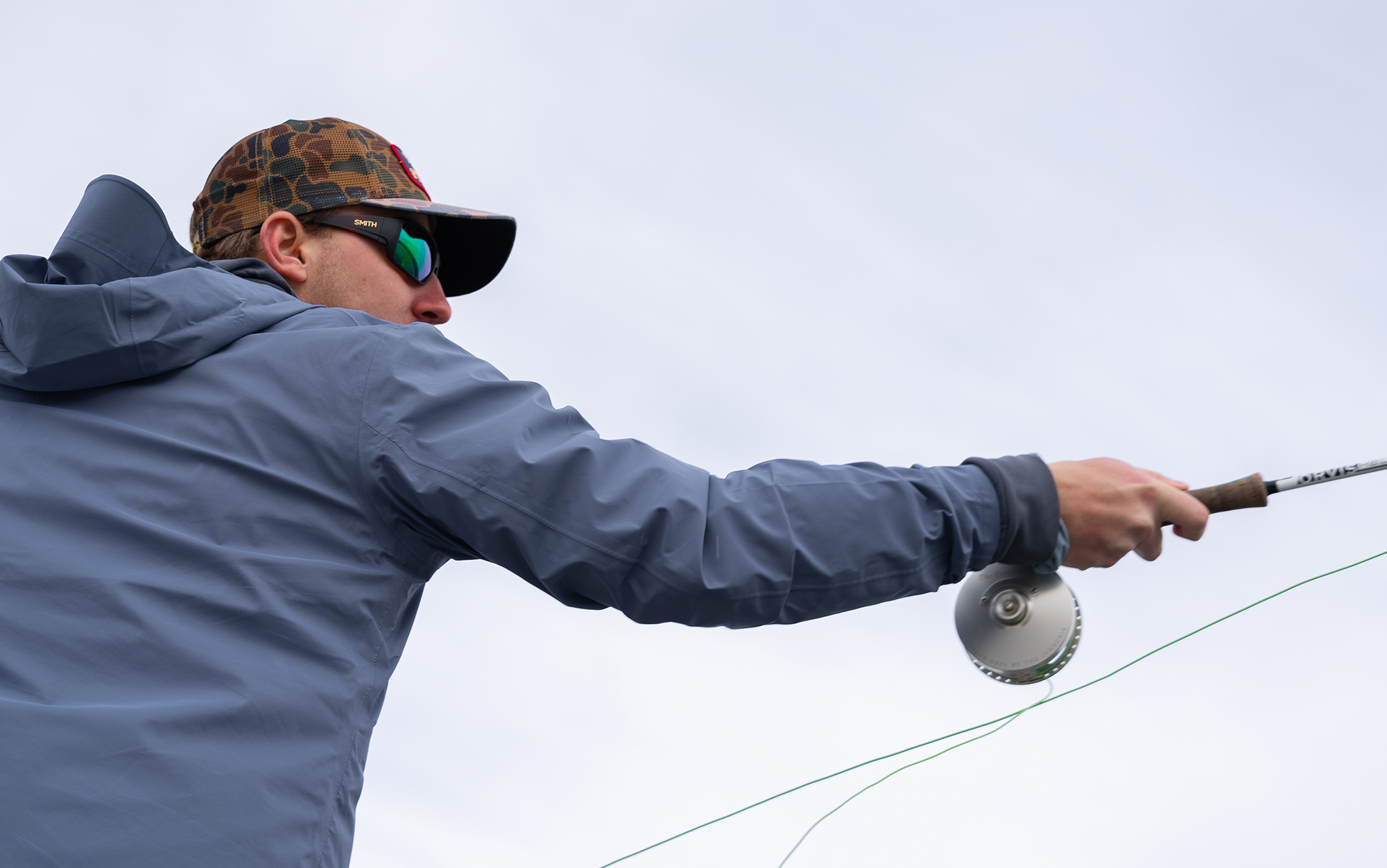 Angler casts wearing Smith Guide's Choice polarized sunglasses.