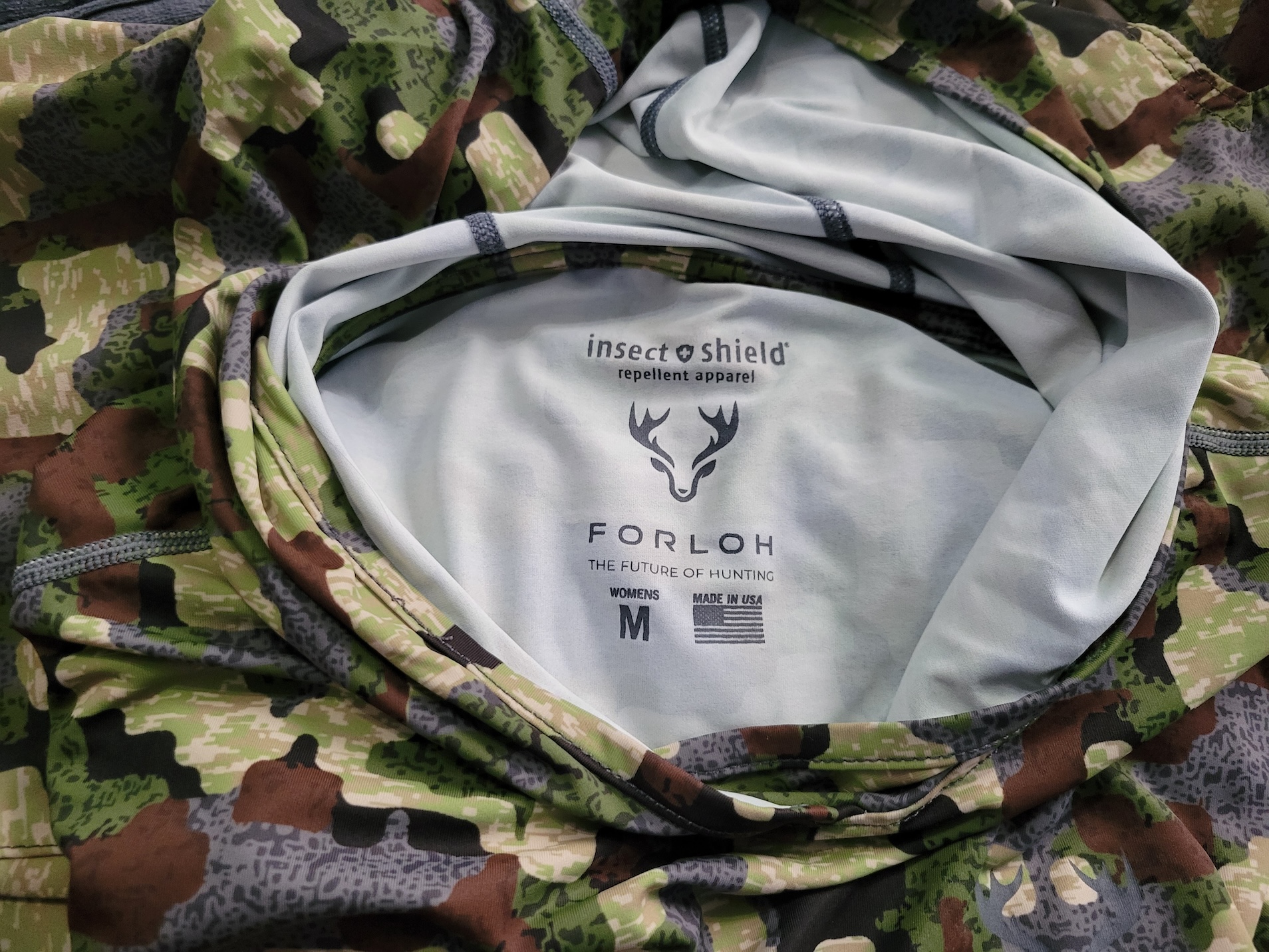 The inside print of Forloh's Insect Shield top with a tag that reads "made in USA"