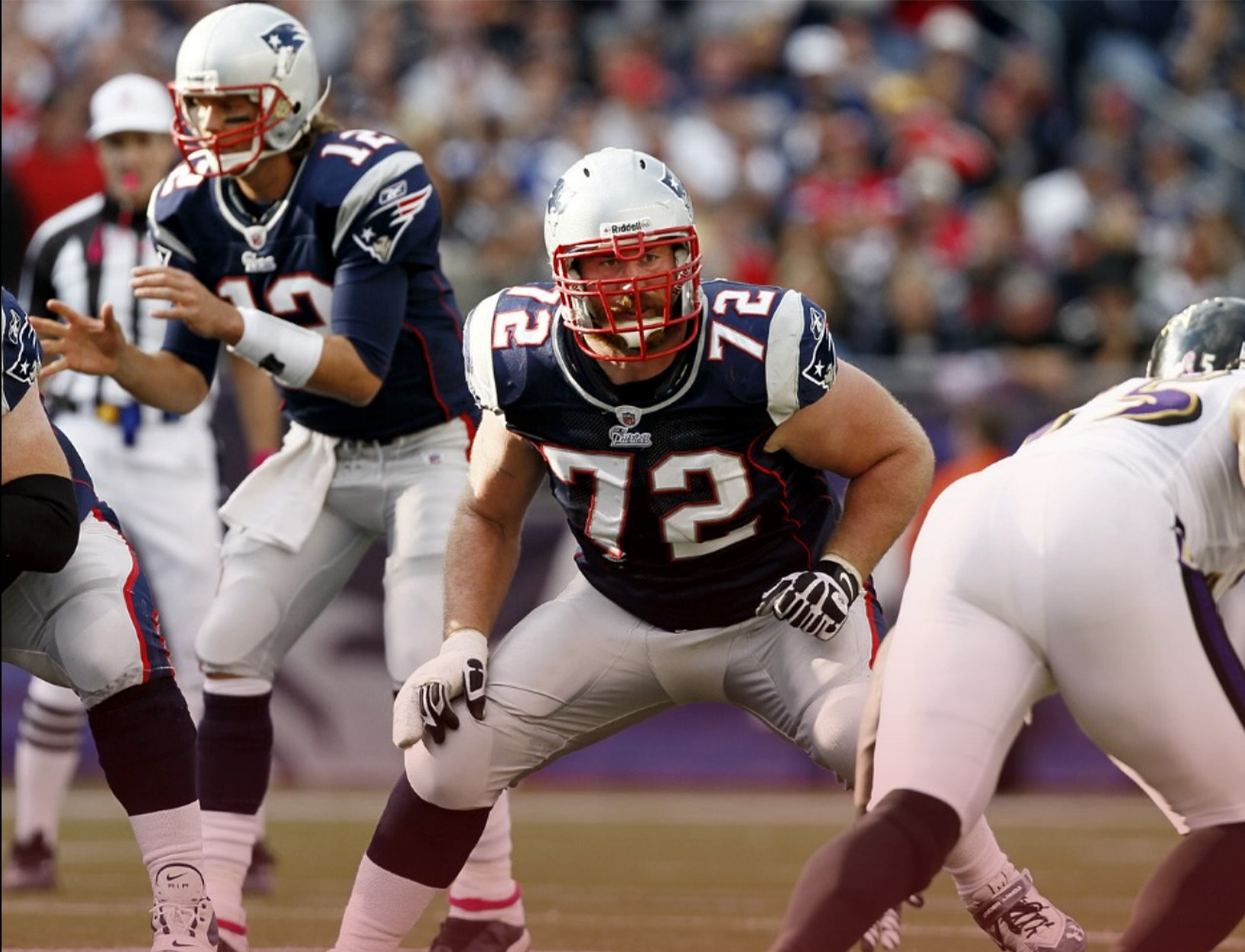 Football players get ready for the snap.