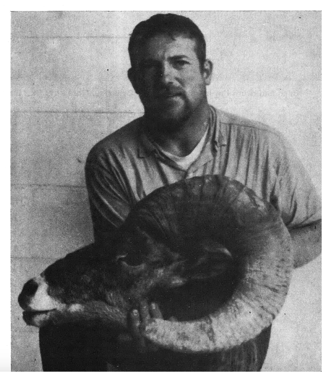 An old photograph of an Oregon hunter with a bighorn sheep head.