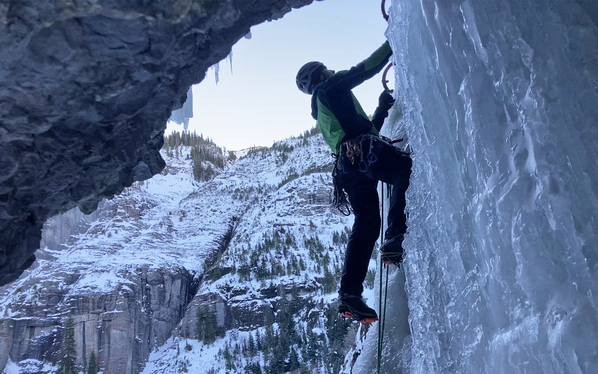 Ice climber ascends column of ice. 