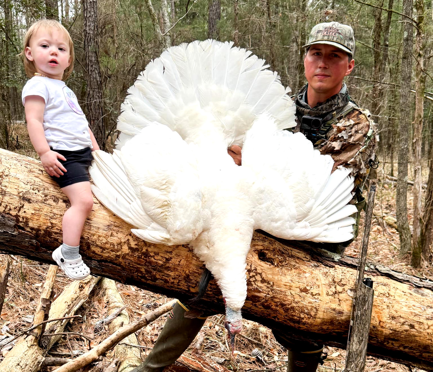 A turkey hunter and his daughter with an all-white gobbler.